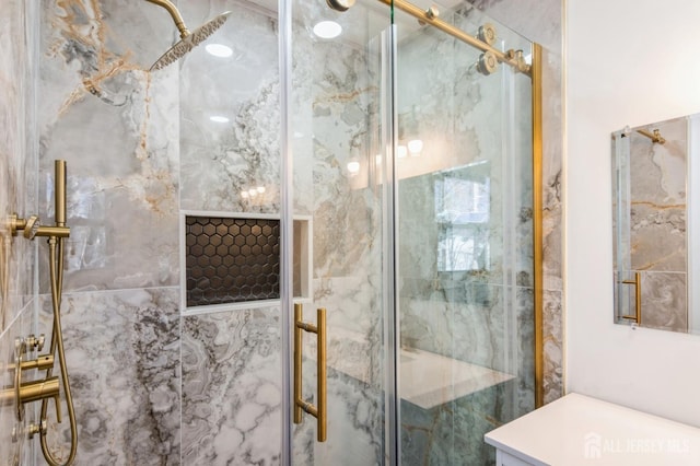 full bathroom featuring a marble finish shower