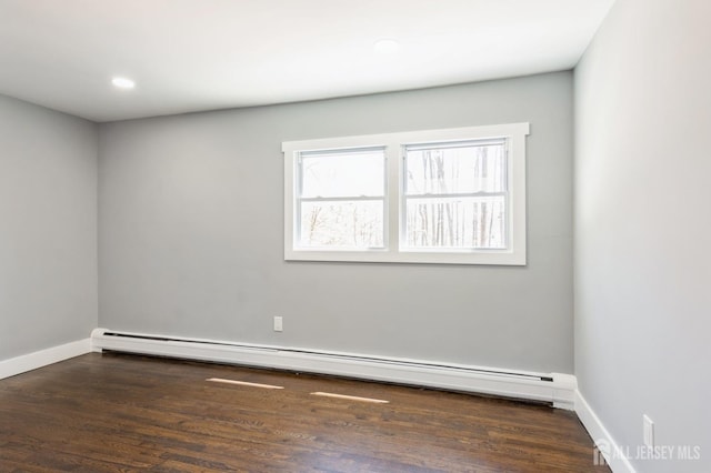 spare room featuring baseboards, recessed lighting, wood finished floors, and baseboard heating