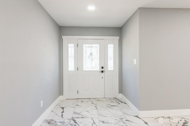 foyer entrance with baseboards and marble finish floor