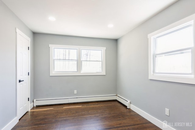 spare room featuring recessed lighting, baseboards, a baseboard radiator, and dark wood-style flooring