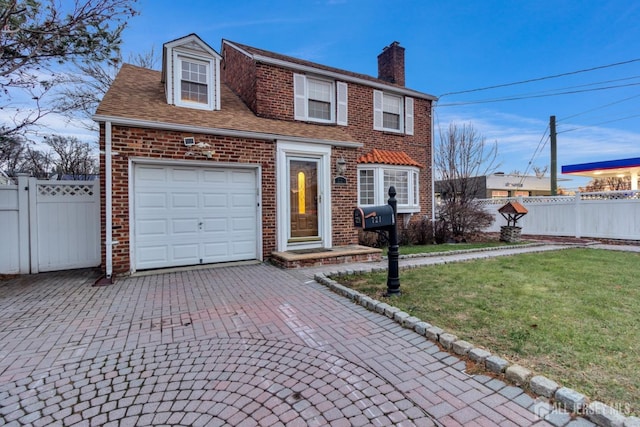 view of front of property with a garage and a front yard