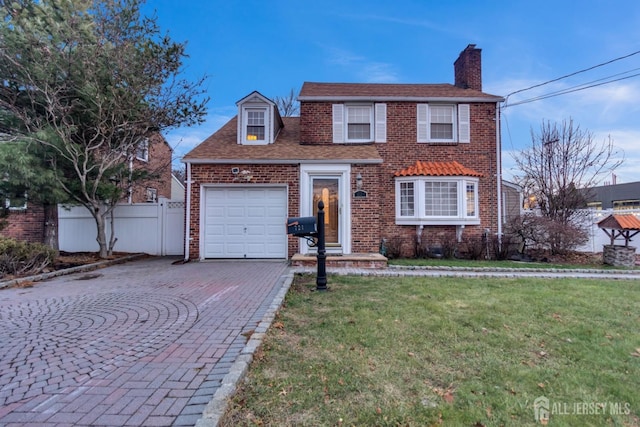 view of front of home with a front yard and a garage