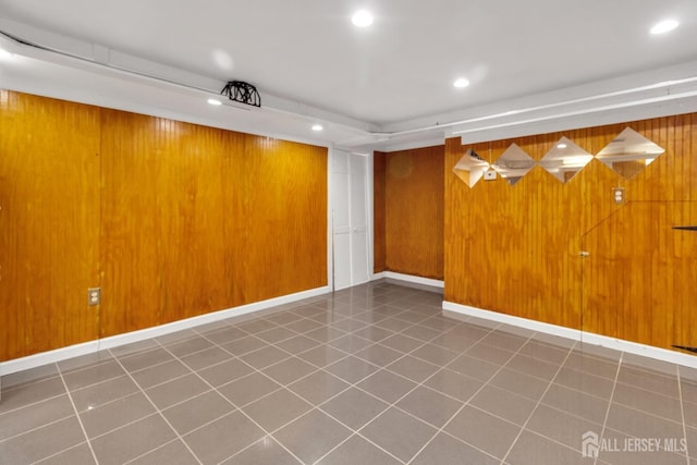 empty room featuring wood walls