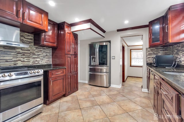 kitchen featuring appliances with stainless steel finishes, light tile patterned floors, dark stone countertops, and decorative backsplash