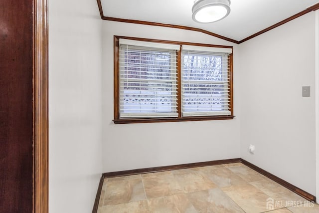 spare room featuring lofted ceiling and crown molding