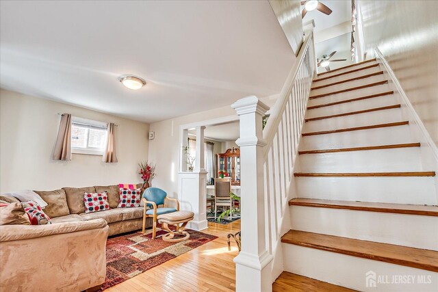 living room with hardwood / wood-style flooring and ornate columns