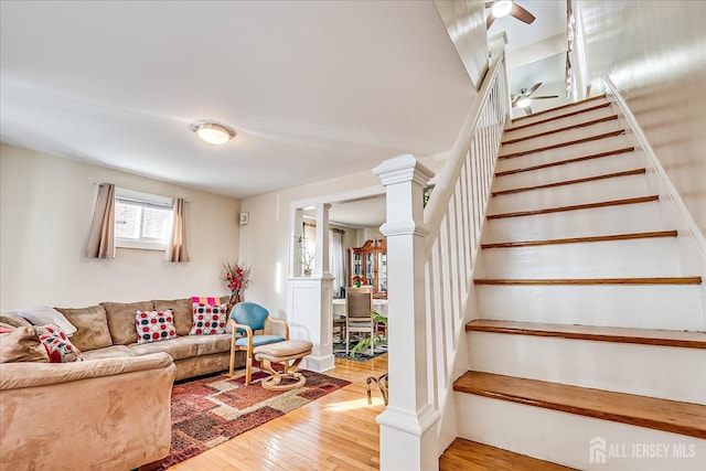 living room featuring decorative columns and hardwood / wood-style floors