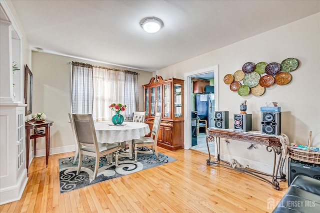 dining space featuring light wood-type flooring