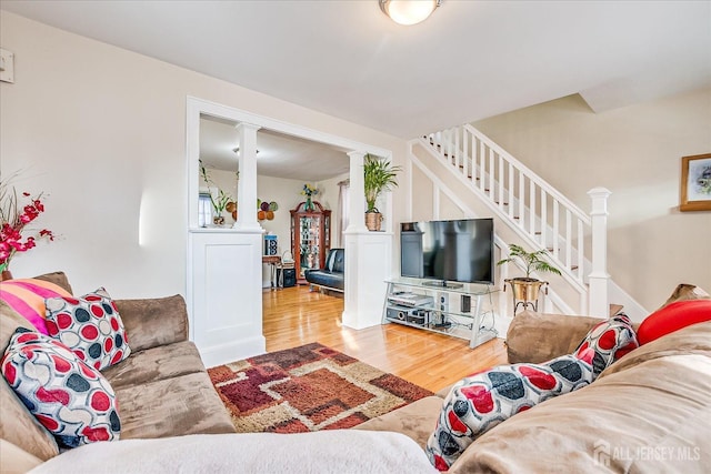 living room featuring hardwood / wood-style floors and ornate columns