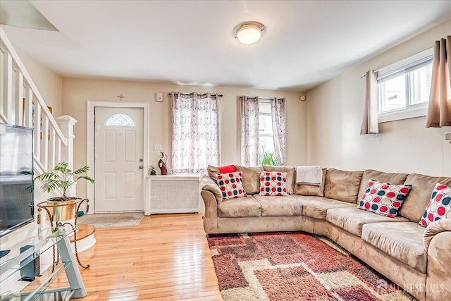 living room with radiator and light wood-type flooring