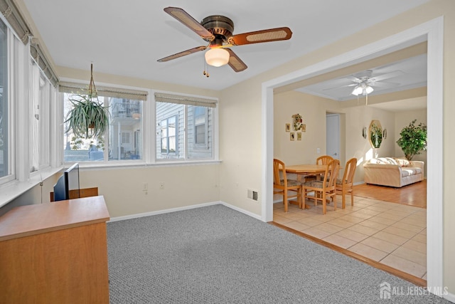 dining space with light tile patterned floors and ceiling fan