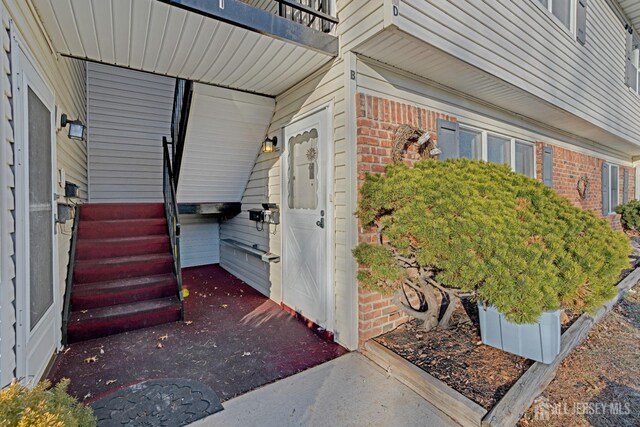 view of exterior entry featuring a balcony