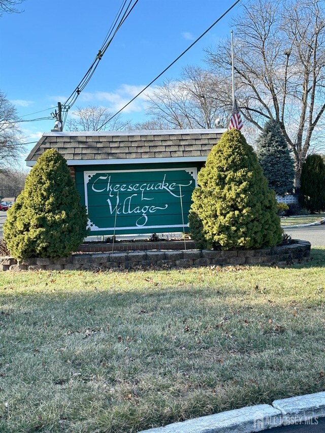 community / neighborhood sign with a yard