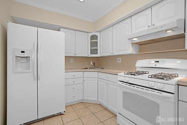 kitchen featuring crown molding, sink, white appliances, and white cabinets