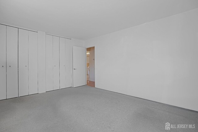 unfurnished bedroom featuring multiple closets