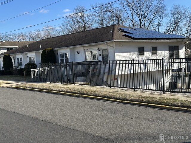 ranch-style home with solar panels