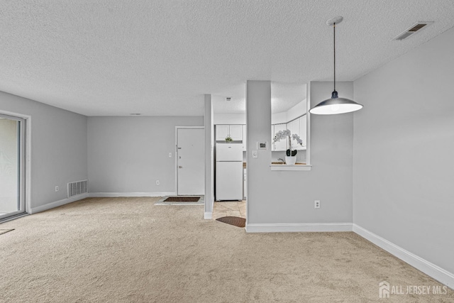 8113 Tamarron Dr, Plainsboro, NJ 08536 - unfurnished living room featuring a textured ceiling, carpet, and baseboards