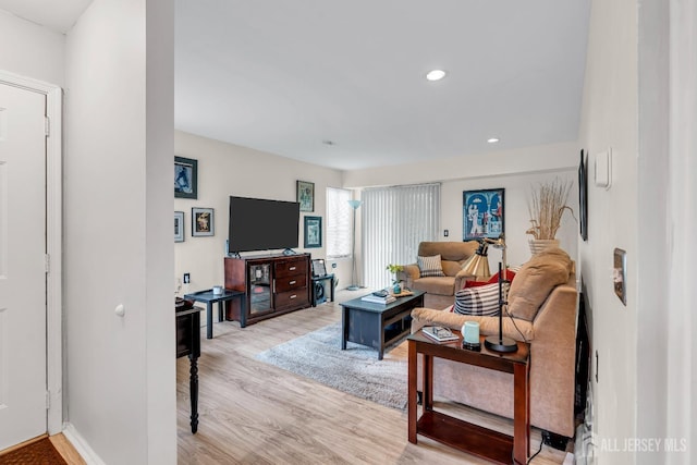 living room with light wood finished floors and recessed lighting
