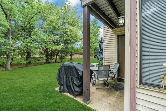 view of green lawn featuring a patio
