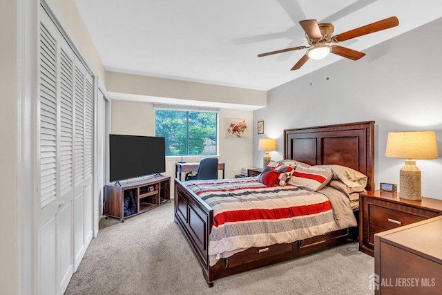 bedroom featuring light colored carpet, a closet, and a ceiling fan