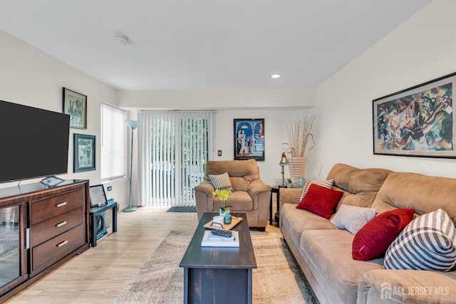 living area with light wood-style floors and recessed lighting
