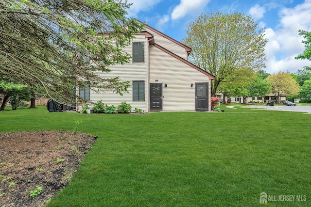 rear view of property with a lawn