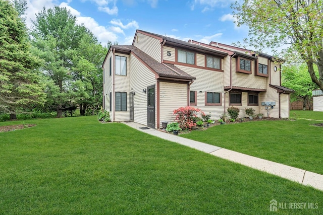 rear view of house with a yard