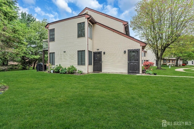 back of property featuring a lawn