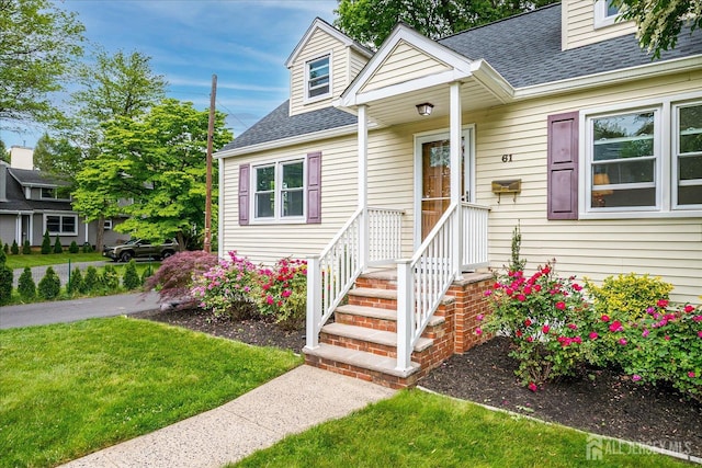 61 Thomas St, Metuchen, NJ 08840 - view of front of house with roof with shingles and a front lawn