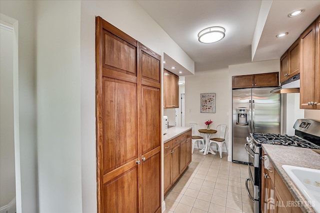 61 Thomas St, Metuchen, NJ 08840 - kitchen featuring stainless steel appliances, light countertops, a sink, under cabinet range hood, and light tile patterned flooring