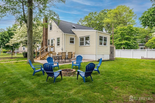 61 Thomas St, Metuchen, NJ 08840 - back of property featuring an outdoor fire pit, a chimney, stairway, a shingled roof, and a storage shed