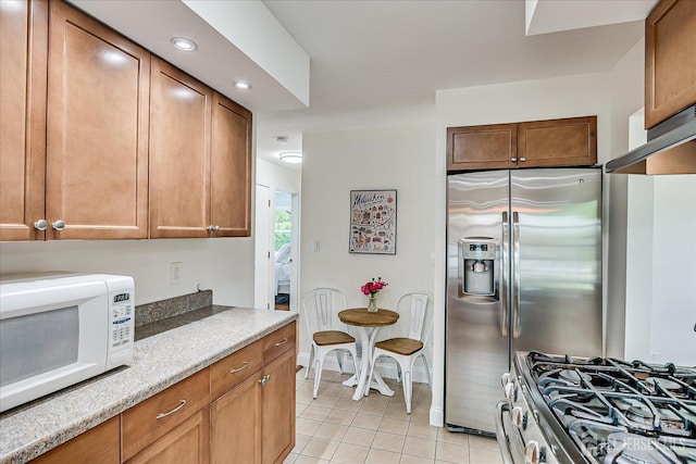61 Thomas St, Metuchen, NJ 08840 - kitchen featuring stainless steel appliances, light tile patterned floors, recessed lighting, and brown cabinets