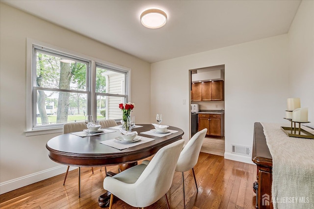 61 Thomas St, Metuchen, NJ 08840 - dining room with light wood-style flooring and baseboards