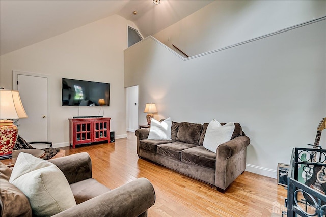 61 Thomas St, Metuchen, NJ 08840 - living room featuring light wood finished floors, baseboards, high vaulted ceiling, and attic access