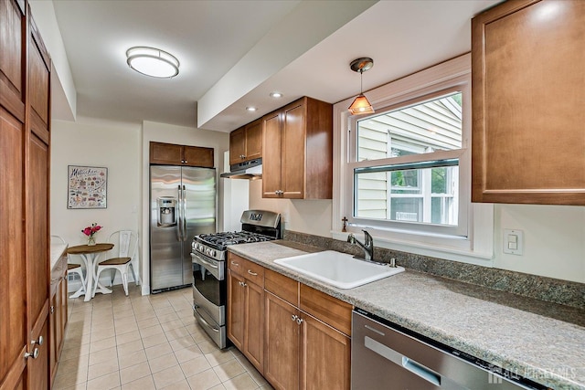 61 Thomas St, Metuchen, NJ 08840 - kitchen featuring appliances with stainless steel finishes, a sink, under cabinet range hood, light tile patterned floors, and brown cabinetry