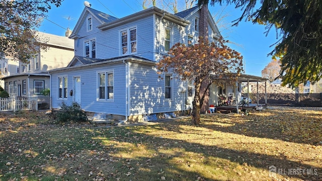 back of property featuring a lawn