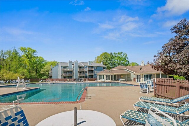 pool featuring fence and a patio