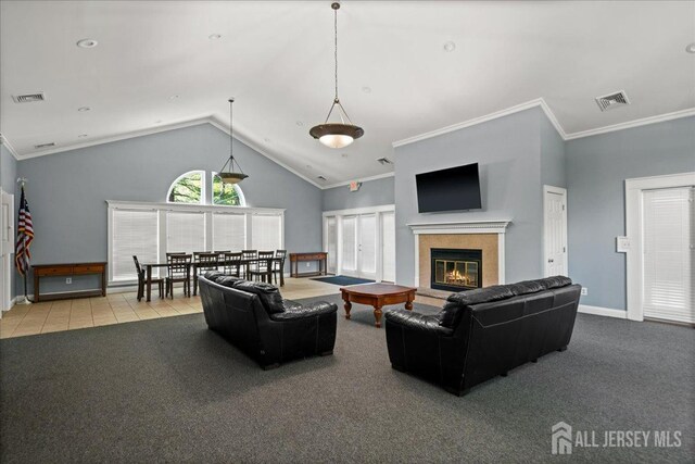 carpeted living room featuring baseboards, visible vents, a glass covered fireplace, and vaulted ceiling
