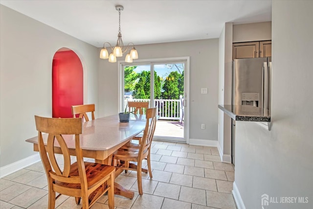 7 Mill Rd, Jamesburg, NJ 08831 - dining area with arched walkways, light tile patterned flooring, a chandelier, and baseboards