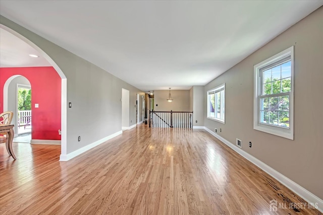7 Mill Rd, Jamesburg, NJ 08831 - empty room featuring light wood-type flooring, baseboards, and arched walkways