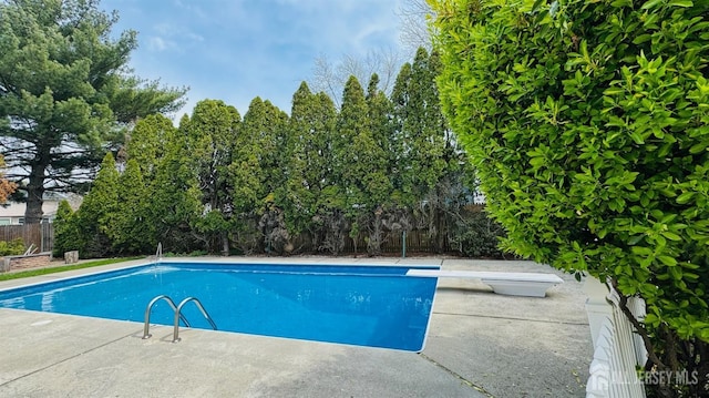 7 Mill Rd, Jamesburg, NJ 08831 - view of swimming pool with a diving board and view of scattered trees