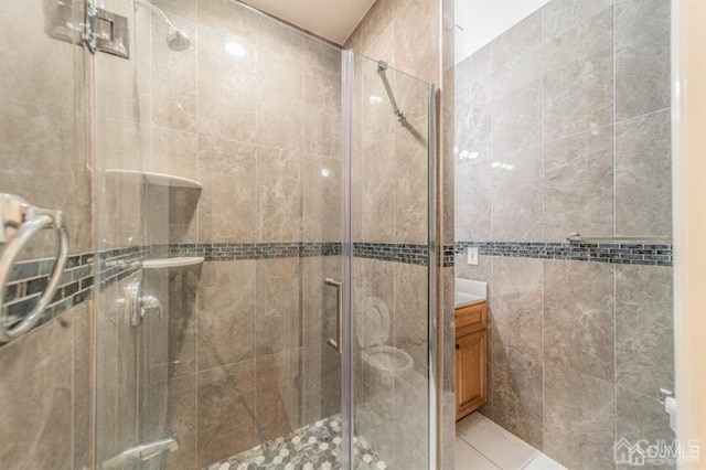 58 S Whittier St, Carteret, NJ 07008 - full bath featuring vanity, a shower stall, and tile walls