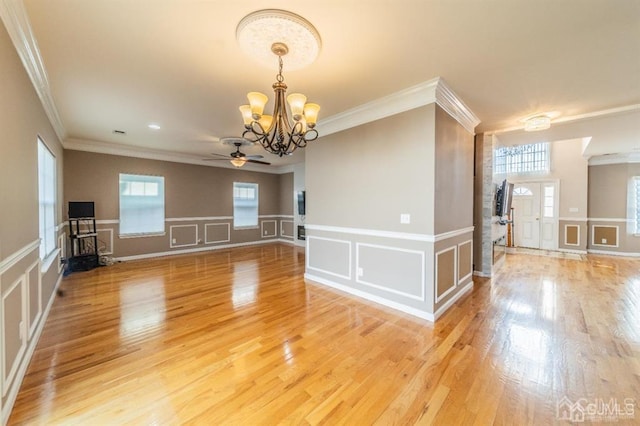 58 S Whittier St, Carteret, NJ 07008 - empty room featuring crown molding, plenty of natural light, a decorative wall, and ceiling fan with notable chandelier