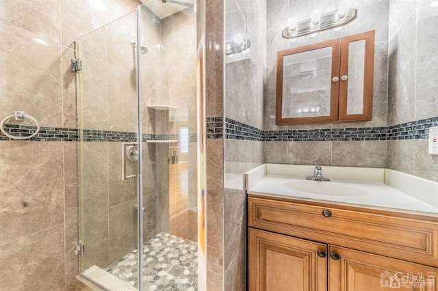 58 S Whittier St, Carteret, NJ 07008 - full bathroom featuring vanity, a stall shower, and tile walls