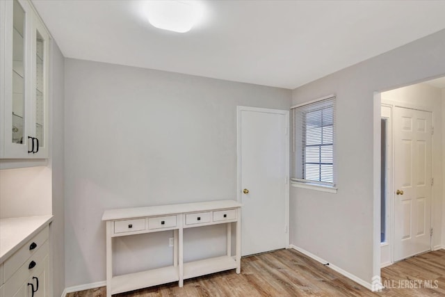 interior space featuring light wood-style flooring and baseboards