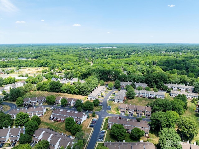 drone / aerial view with a residential view and a wooded view