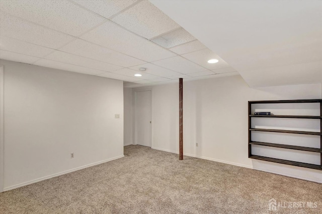 finished below grade area with recessed lighting, baseboards, carpet floors, and a paneled ceiling