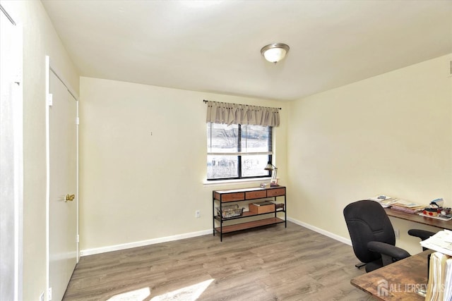 home office featuring wood finished floors and baseboards