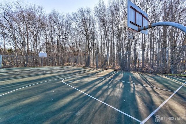 view of basketball court featuring community basketball court and fence