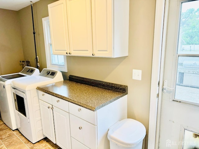 laundry room featuring separate washer and dryer and cabinet space